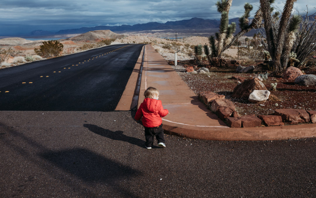 baby walking on open desert road in Nevada near Lake Mead