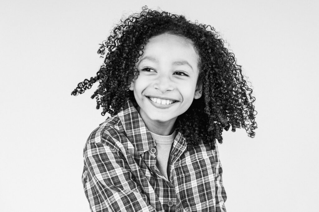 black and white portrait of child smiling