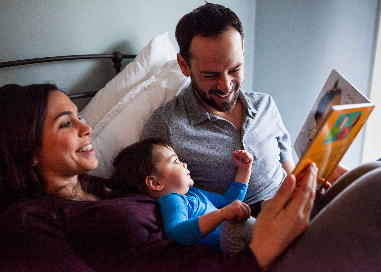 family reading in bed